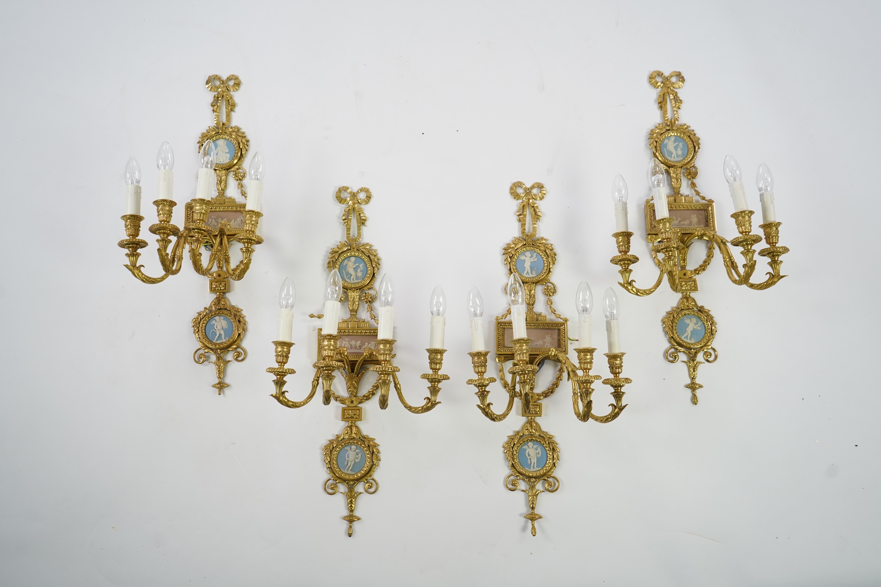 A set of four Adam style ormolu and jasper ware mounted wall appliques, early 20th century